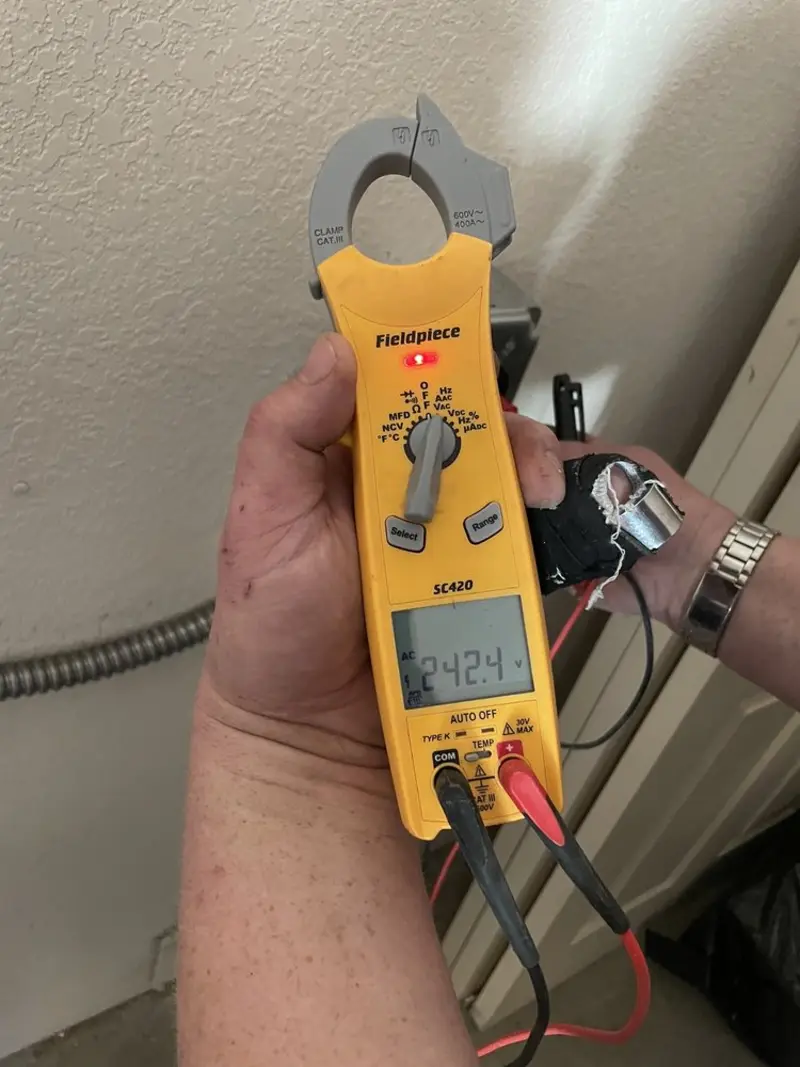 Voltage testing with clamp meter during Electrical Installation Services in Heathrow